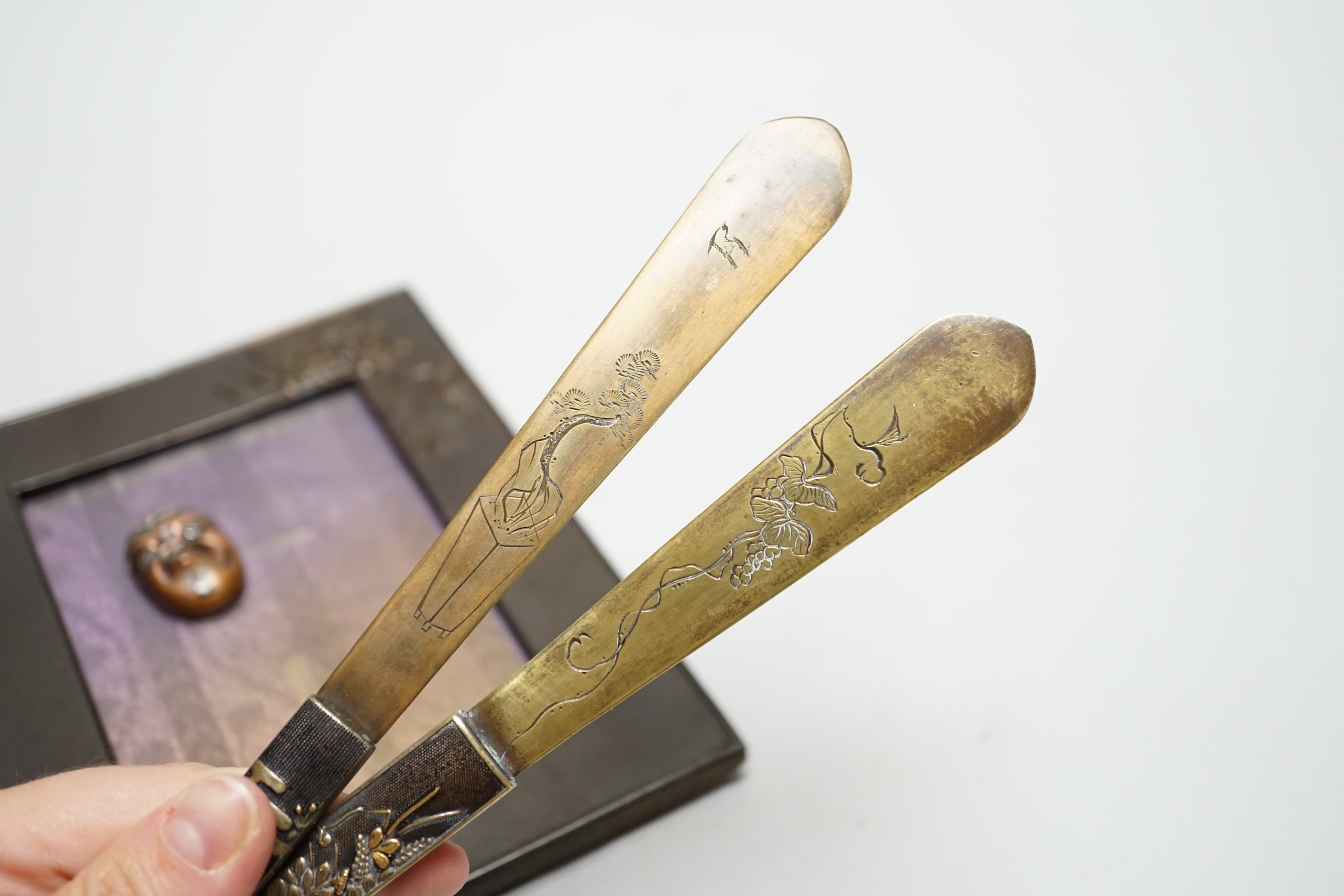 Four Japanese items comprising two mixed metal kazuka handles later converted to page turners, a photo frame and a noh mask mount, largest 21.5cm in length